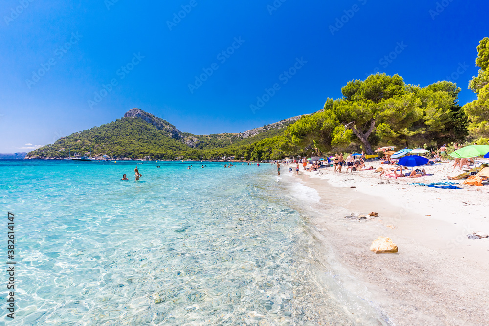 Platja de Formentor, Mallorca, Spain - July 20, 2020: People enjoying popular beach in summer, Mallorca, Spain.