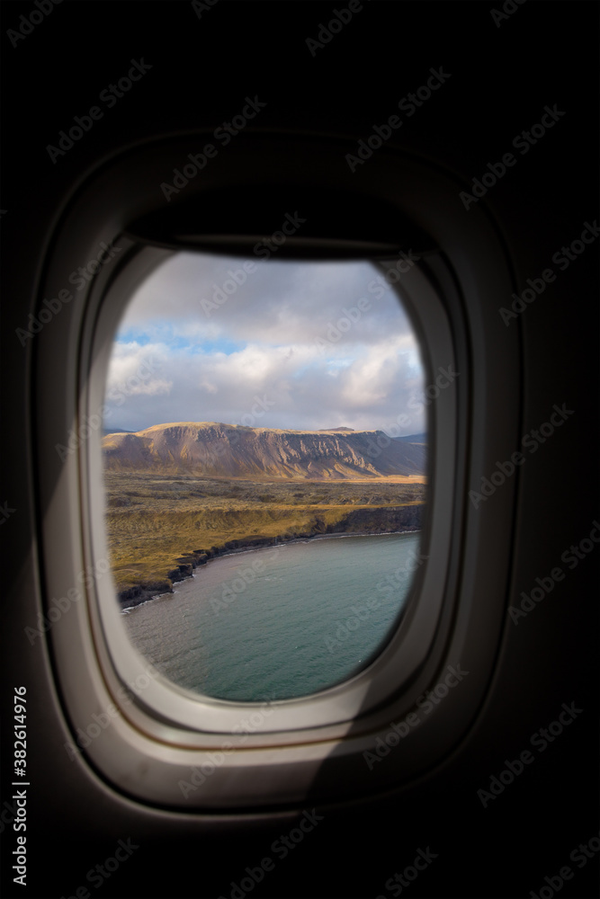 Airplane interior with window view of the coast in Iceland Airplane interior with window view of the coast in Iceland