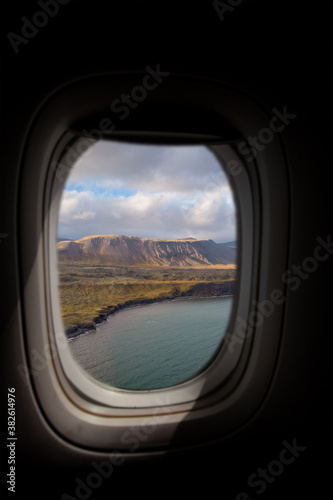Airplane interior with window view of the coast in Iceland