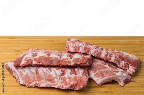 Close up view of raw pork ribs on wooden cutting broad. Cooking and food concept.