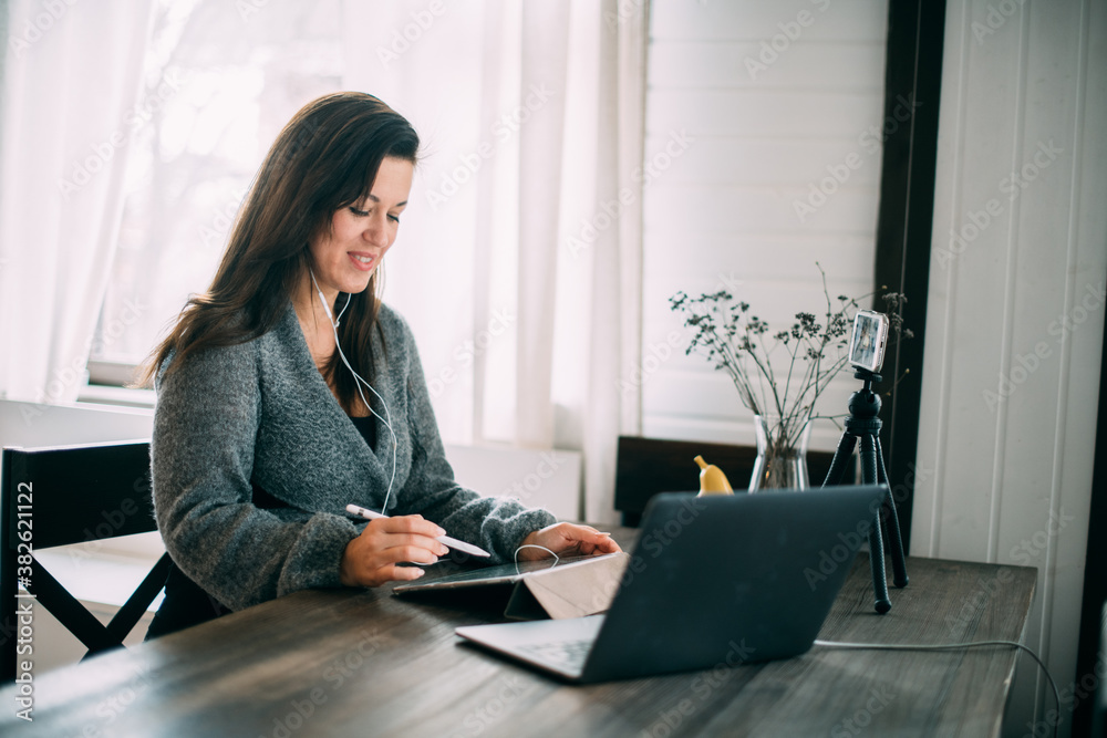 A woman works, conducts live broadcasts from home on the Internet A woman works, conducts live broadcasts from home on the Internet