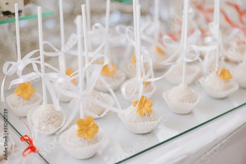 Sweet dessert cakes and cupcakes and jellys on the candy bar at the celebration