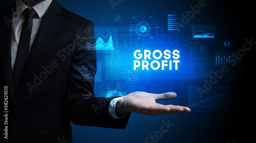 Hand of Businessman holding GROSS PROFIT inscription, business success concept