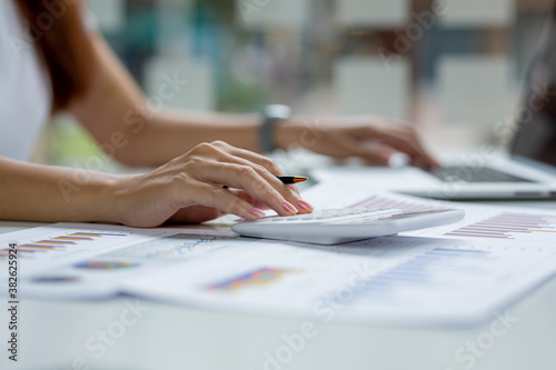 Asian businesswoman hands hold documents with financial statistic stock photo discussion and analysis data the charts and graphs. Finance concept