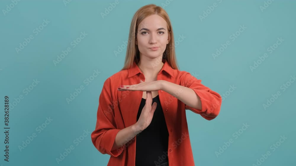 Stop, you need a break. Close up of a dissatisfied, young woman making the time out gesture, asking for a break before the deadline. Stop, you need a break. Close up of a dissatisfied, young woman making the time out gesture, asking for a break before the deadline.