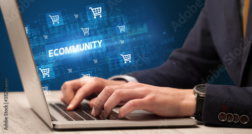 Businessman working on laptop with ECOMMUNITY inscription, online shopping concept