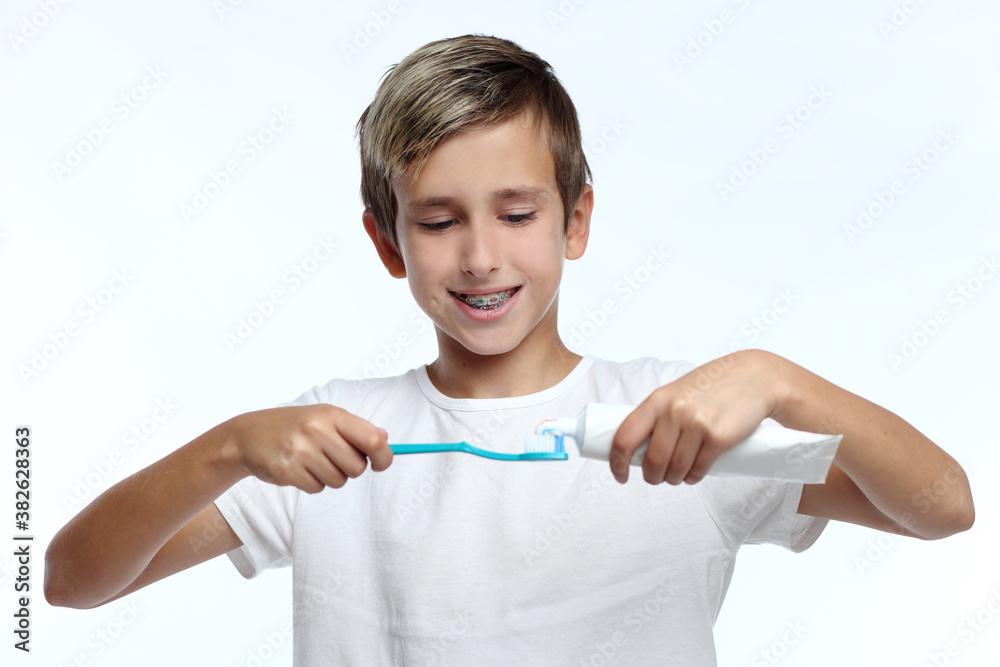 Kid holding toothbrush and putting paste from toothpaste Kid holding toothbrush and putting paste from toothpaste