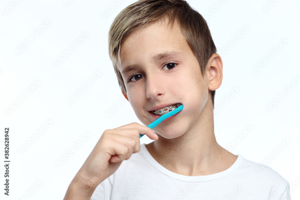 boy cleaning his teeth over white background boy cleaning his teeth over white background