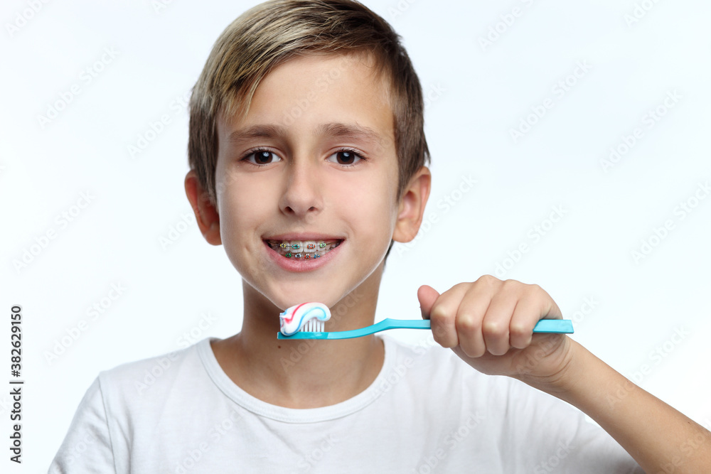 boy cleaning his teeth over white background boy cleaning his teeth over white background