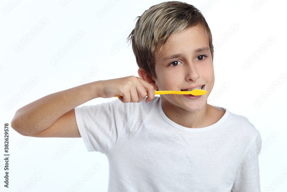 boy cleaning his teeth over white background boy cleaning his teeth over white background
