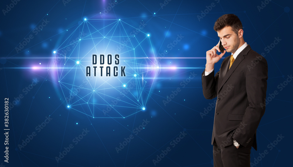 Businessman thinking about security solutions with DDOS ATTACK inscription Businessman thinking about security solutions with DDOS ATTACK inscription