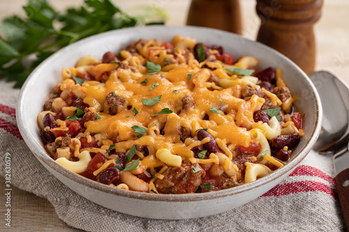 Bowl of chili mac with cheddar cheese