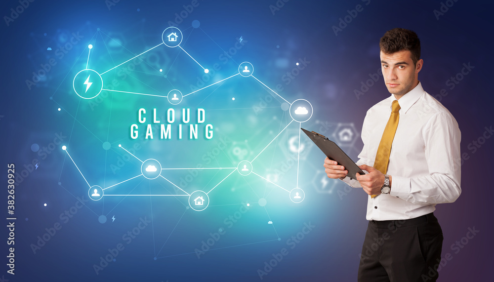 Businessman in front of cloud service icons with CLOUD GAMING inscription, modern technology concept Businessman in front of cloud service icons with CLOUD GAMING inscription, modern technology concept
