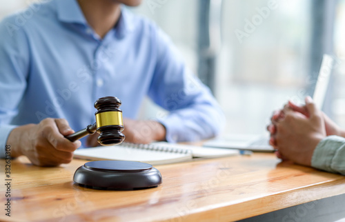 Close-up shot of Lawyer holding a hammer giving advice on the law,Concept of justice.