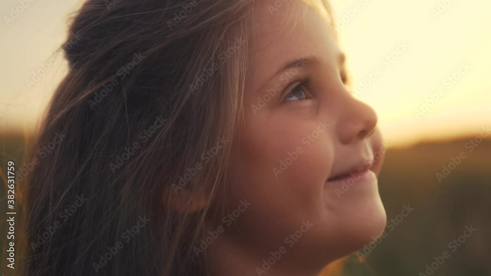 happy little girl child look up dreams. kid wants a dream come true portrait at sunset. baby daughter silhouette dreaming of a happy childhood. free face sister side view thinks. concept dream