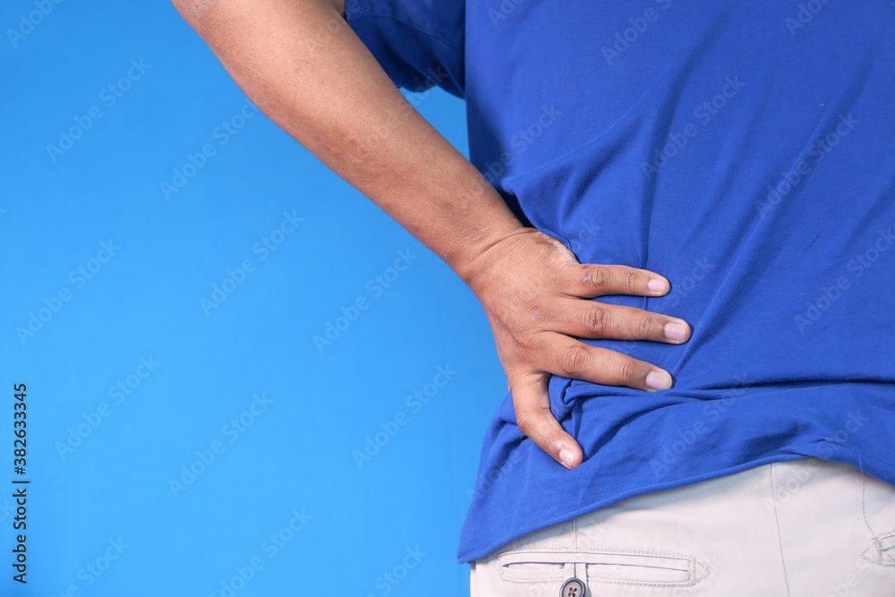 young man suffering back pain close up