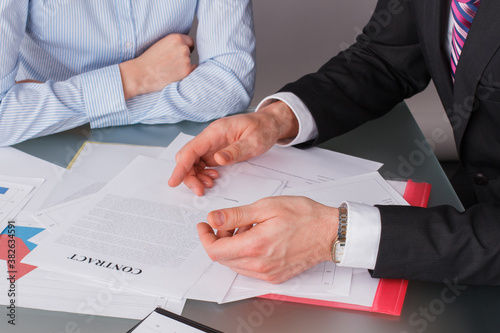 Businessman and business woman at business meeting. Business people discussing business papers.