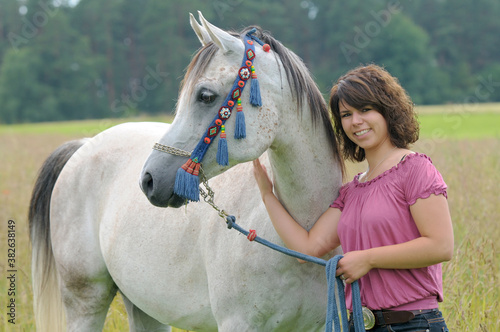 woman and proud arabian stallion