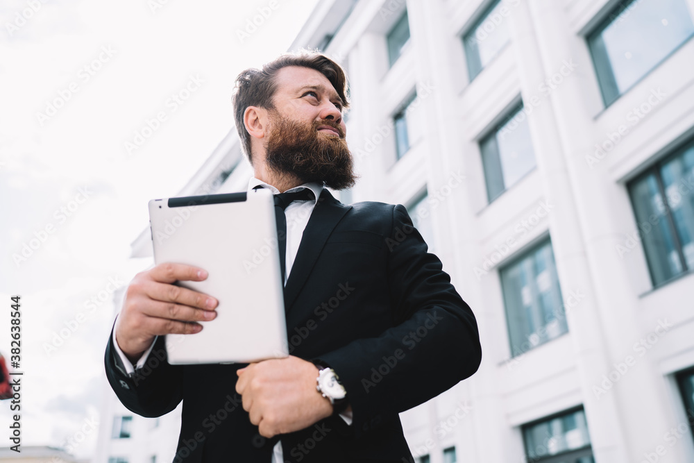 Confident entrepreneur with tablet on street Confident entrepreneur with tablet on street