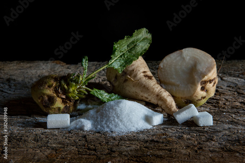 sugar beet and white sugar on an old wooden table