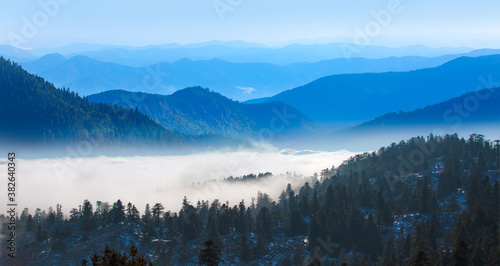 Beautiful landscape with cascade blue mountains at the morning - View of wilderness mountains during foggy weather