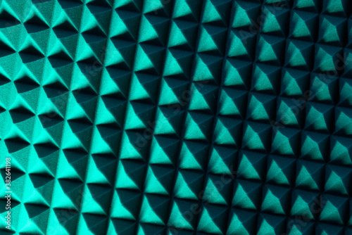 Abstract pyramid background in colored light. Sound insulation material