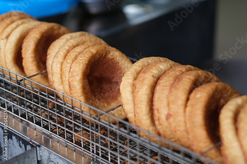 close up Chinese doughnuts (also called salty doughnut and mianwo) on grill. Famous traditional snack in Wuhan, China photo