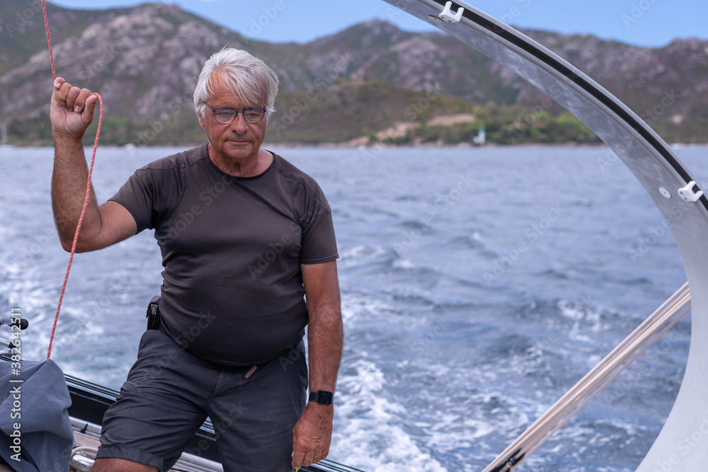 A man sailing a boat in the Mediterranean Sea A man sailing a boat in the Mediterranean Sea