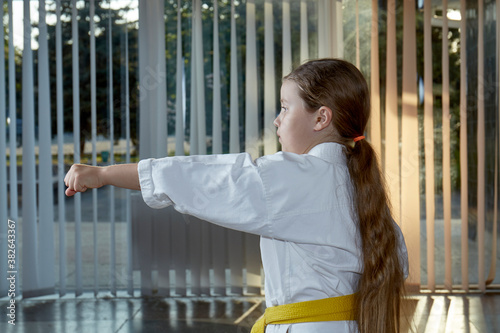 Girl athlete trains hand punch