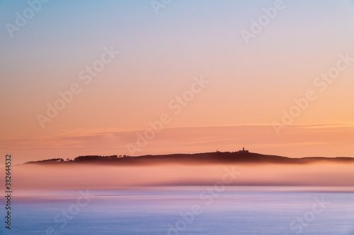 Panorama view of Ons and Onza islands in the R  a de Pontevedra in Galicia under heavy fog  Spain.