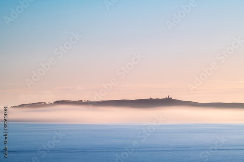 Panorama view of Ons and Onza islands in the R  a de Pontevedra in Galicia under heavy fog  Spain.