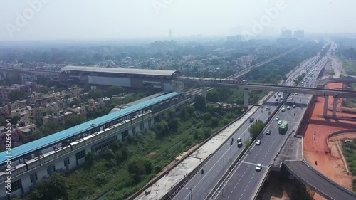 An aerial shot of the Delhi metro leaving the station in Mayur Vihar,New Delhi, India photo