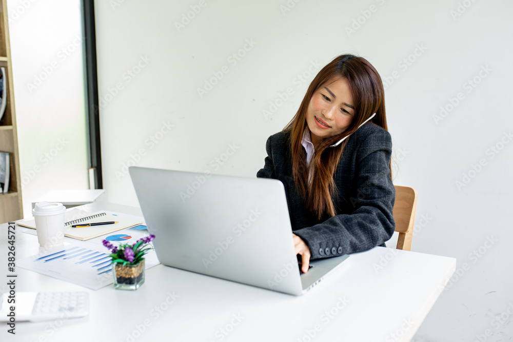 Portrait of businesswoman working on laptop in her workstation. business ideas and note-taking. Portrait of businesswoman working on laptop in her workstation. business ideas and note-taking.