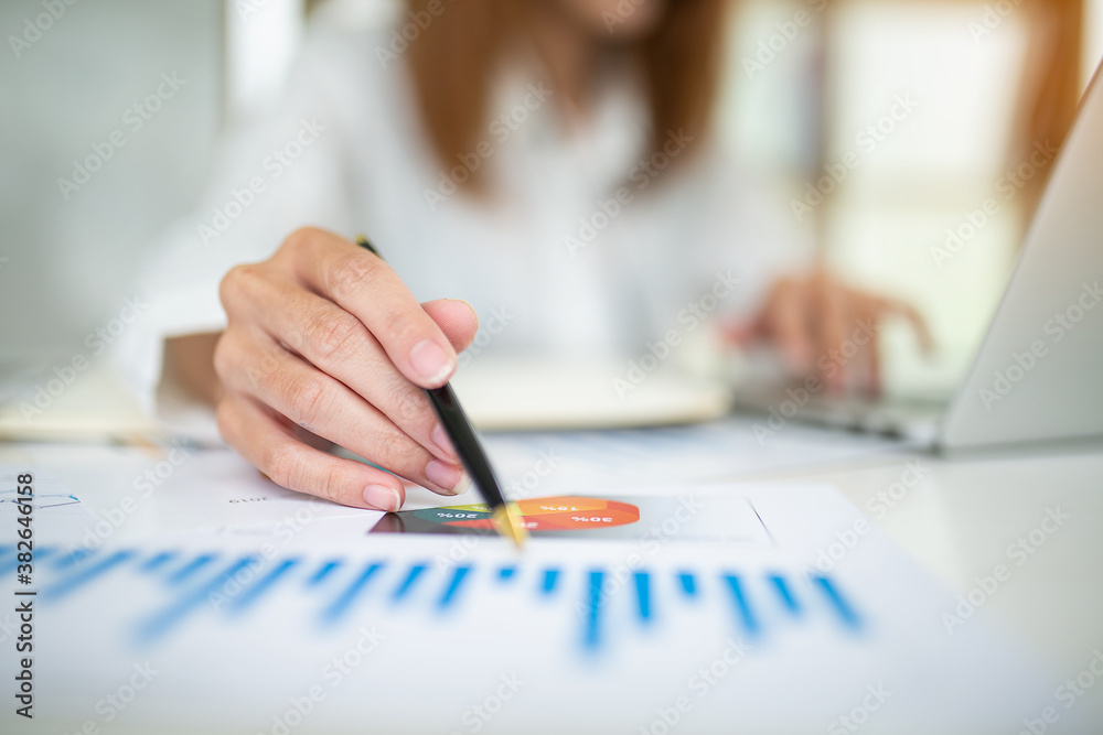 Financial Businesswomen analyze the graph of the company's performance to create profits and growth, Market research reports and income statistics, Financial and Accounting concept. Financial Businesswomen analyze the graph of the company's performance to create profits and growth, Market research reports and income statistics, Financial and Accounting concept.
