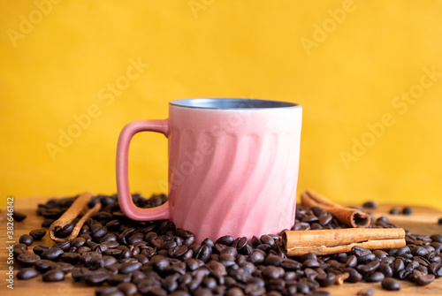 Close up of coffee cup against Yellow background 