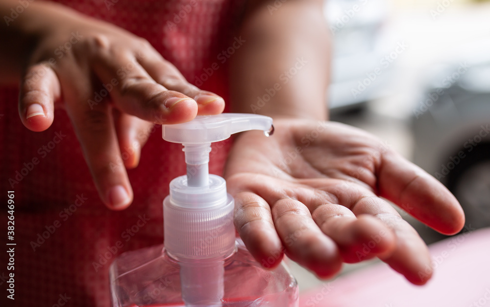 women washing hands with alcohol gel at restaurant women washing hands with alcohol gel at restaurant
