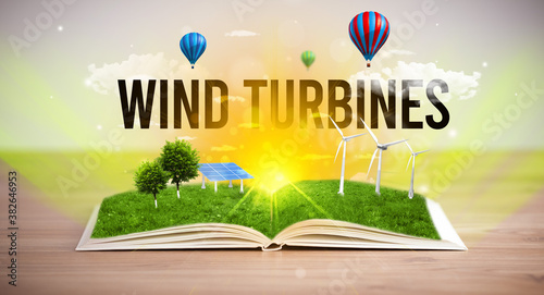 Open book with WIND TURBINES inscription, renewable energy concept