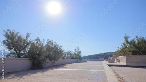Promenade by the sea on a beautiful summer morning. Adriatic coast in Croatia. Postira, island of Brac.

