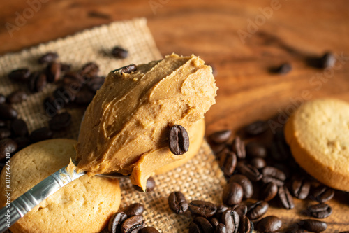 Spoon with peanut butter  and coffee beans