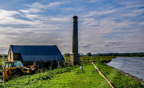 Pumphouse on the bank of the River Yare in RSPB Strumpshaw Fen Nature Reserve in the Norfolk Broads National Park photo