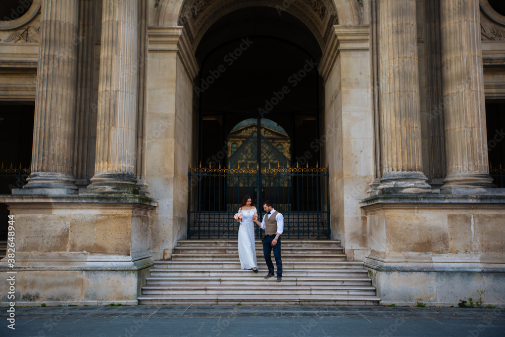 wedding couple. The bride in a beautiful wedding dress, the bride in a stylish tuxedo, Paris France