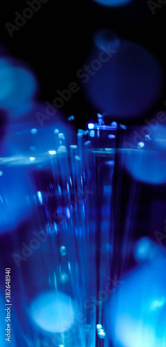 This picture displays colored bottle lights which look like fiber optic cables. The background is black.