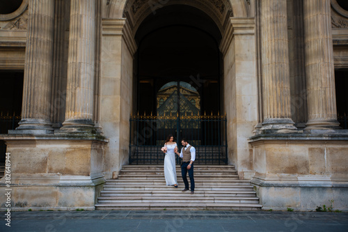 wedding couple. The bride in a beautiful wedding dress, the bride in a stylish tuxedo, Paris France © ostap_davydiak