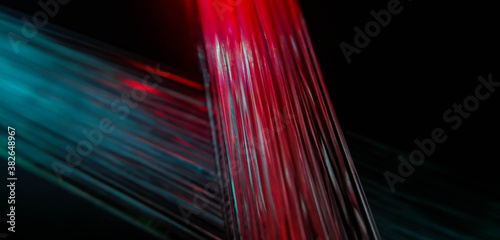 This picture displays colored bottle lights which look like fiber optic cables. The background is black.