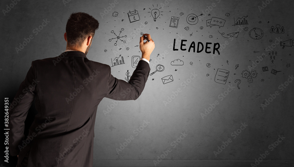 businessman drawing a creative idea sketch with LEADER inscription, business strategy concept businessman drawing a creative idea sketch with LEADER inscription, business strategy concept