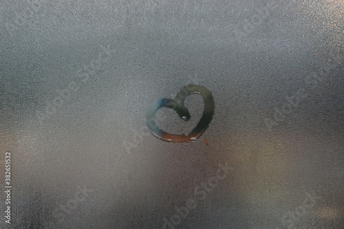 condensation water droplets in mirror for background.Hand Drawn heart on the window