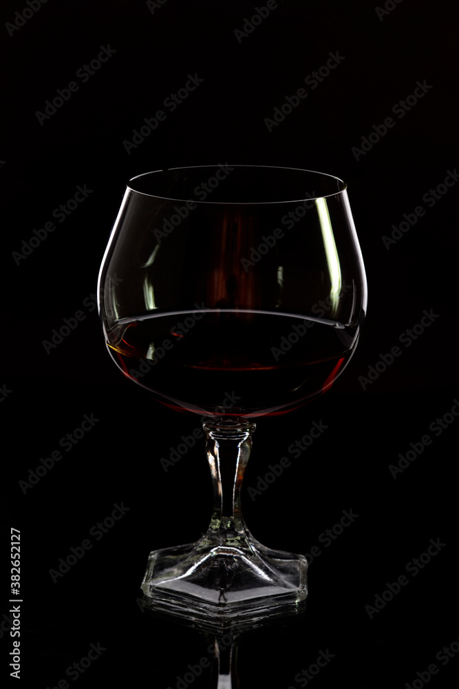 Glass with cognac on a black background Glass with cognac on a black background