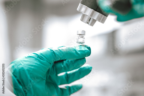 Pharmacist preparing vaccine against coronavirus, covid-2019, pharmaceutical industry concept