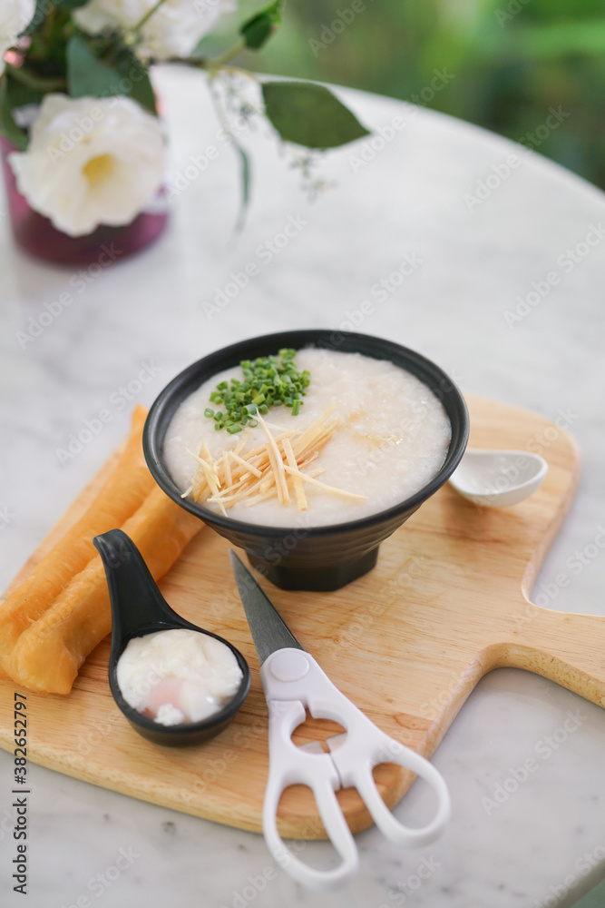 Porridge. A bowl of hot porridge with focus on sliced ginger. Porridge, sometimes called Congee, normally served with boiled egg and deep fried dough sitck.