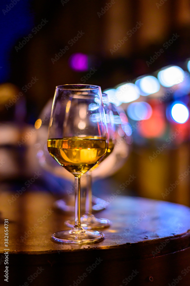 Two glasses of cold dry white wine served outdoor in cafe at night in Italy Two glasses of cold dry white wine served outdoor in cafe at night in Italy